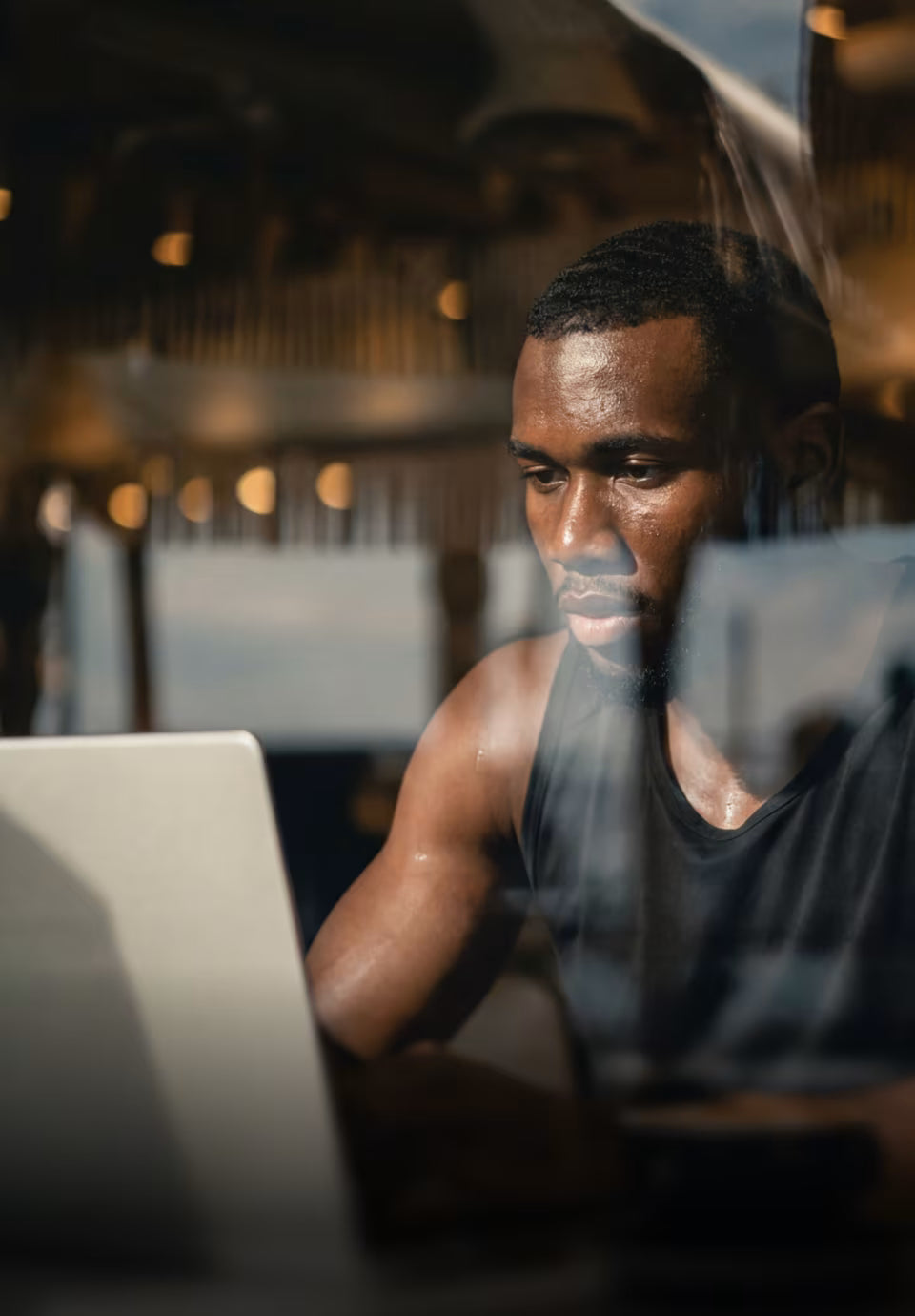 Man using a laptop in a dimly lit room