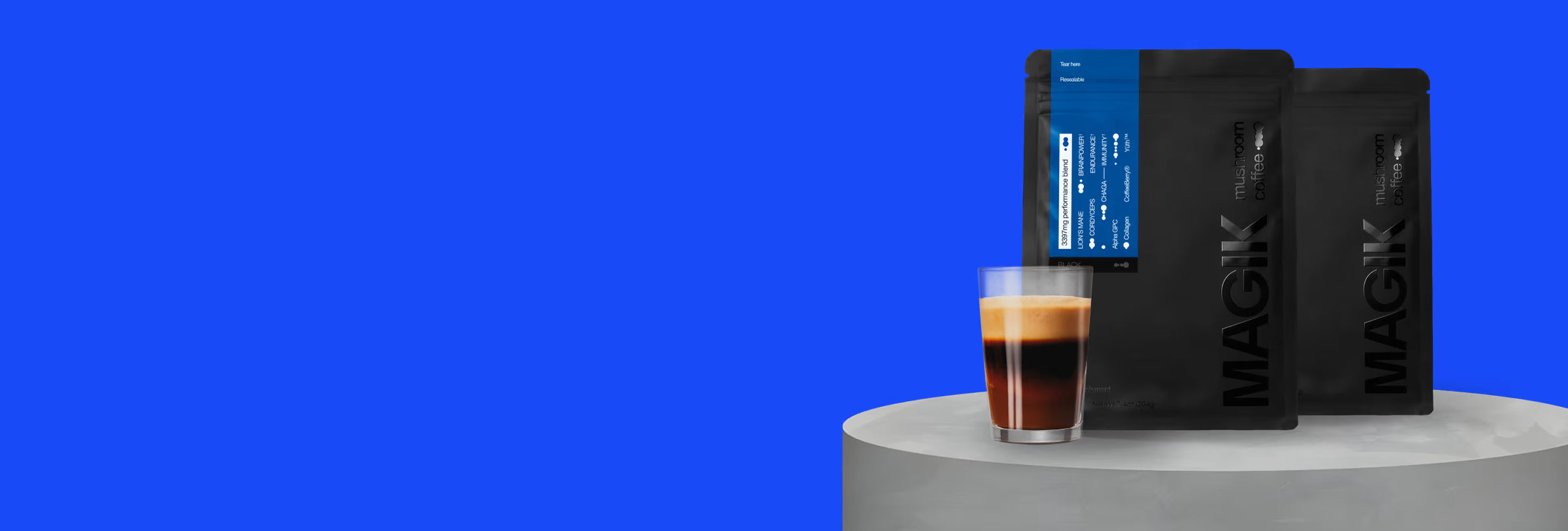 Glass of coffee with Magik coffee bags on a blue background